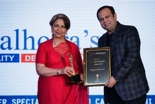 Dr. Malhotra's receiving the Best Dental Award