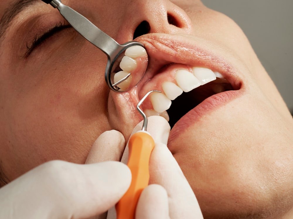 A dentist examining a patient's teeth during a routine check-up